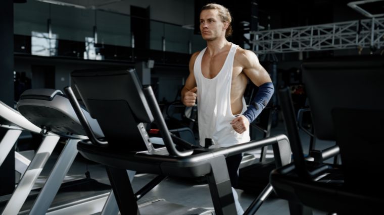 An athlete working out on a treadmill in the gym.