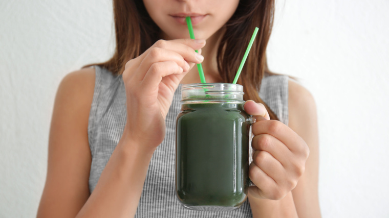 A person drinking a shake.