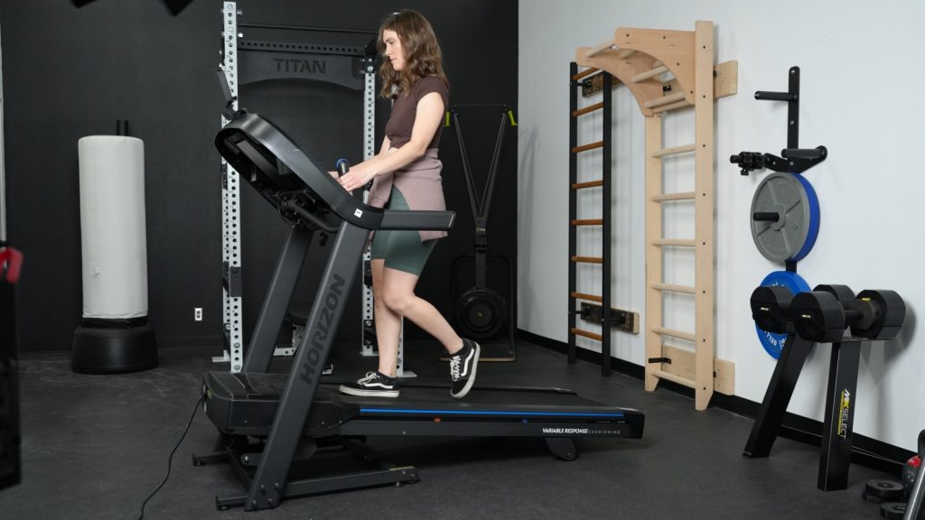 A woman walks at an incline on the Horizon 7.0 treadmill