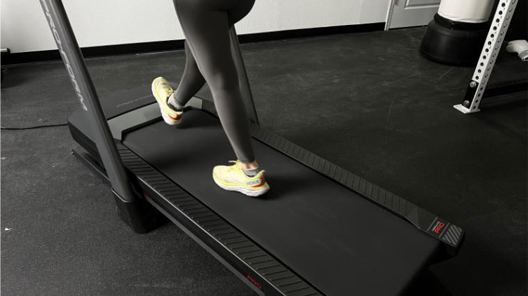 A close up of someone walking on a ProForm Pro 9000 treadmill.