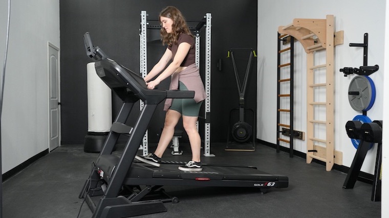 Our tester walking on an incline with the Sole F63 treadmill