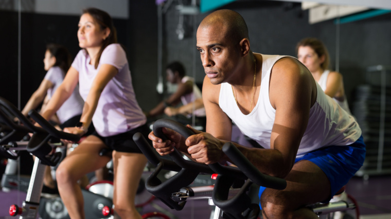 Fit individuals working out in the gym.