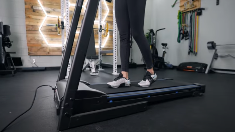 The lower half of a person can be seen walking on an XTerra TR150 treadmill