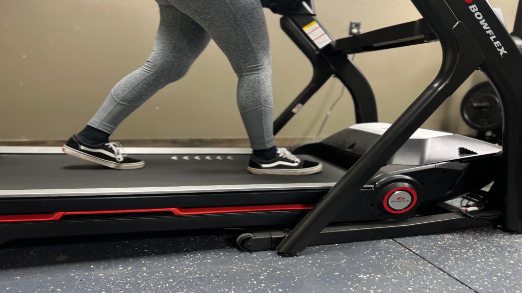 Our BarBend Tester walks on a Bowflex Treadmill.