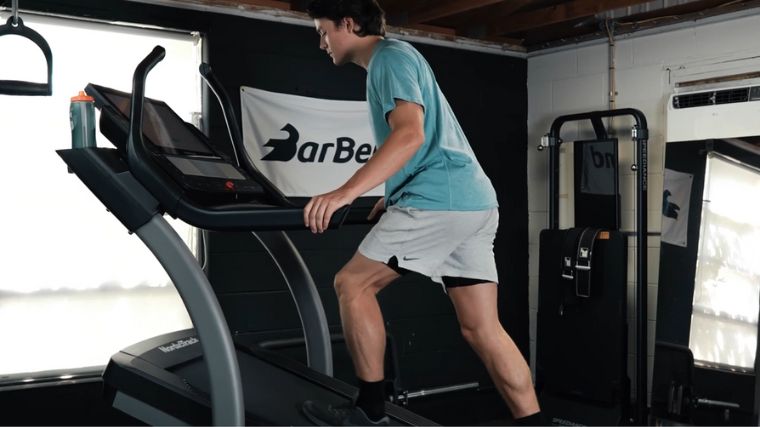 A person working out on an incline treadmill.